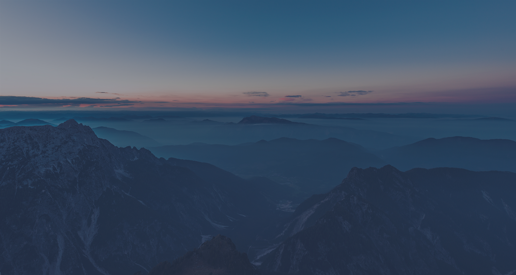 Background image which includes mountains with different tones of blue